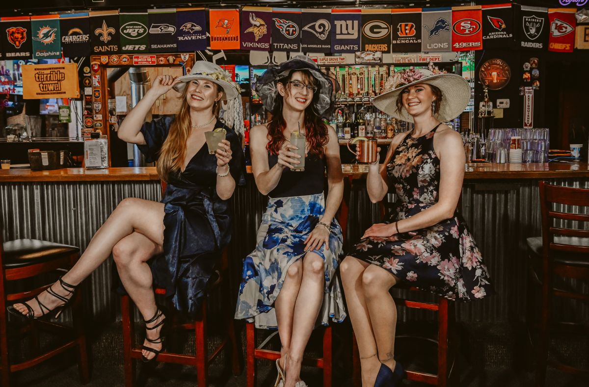 Three females dressed for the Kentucky Derby Party at Firehouse Brewing Co.